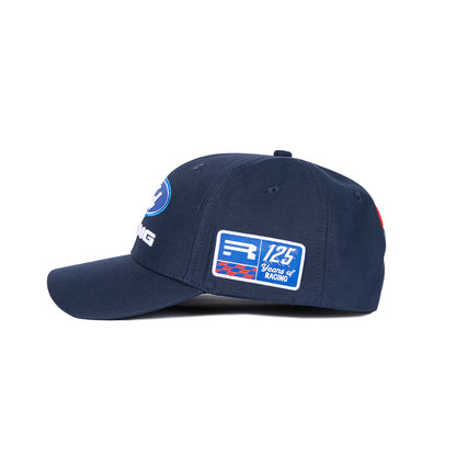 A navy blue baseball cap with embroidered patches, including a prominent 'Racing Point 125 Years of Racing' patch on the side, shown against a plain white background.