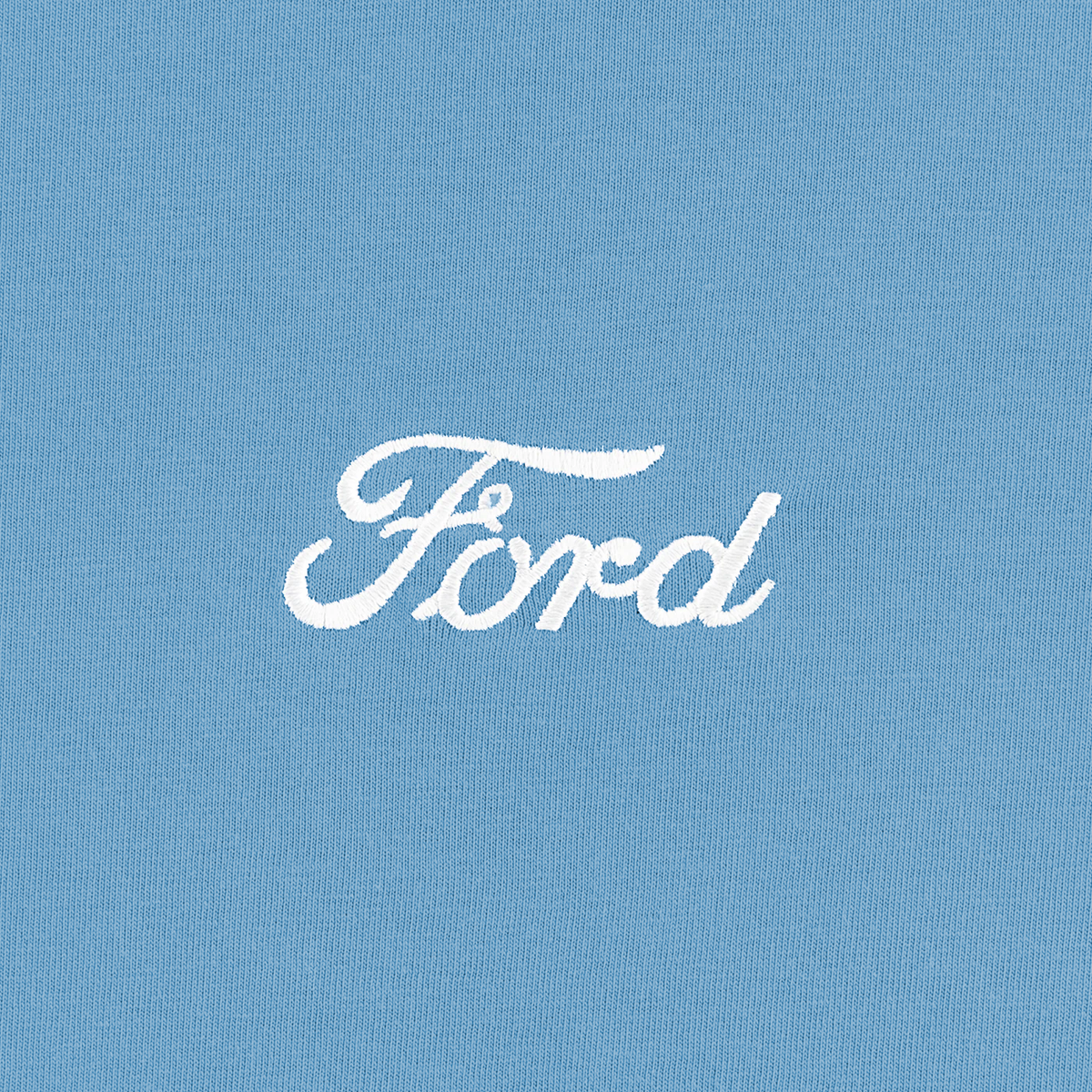 close up of white Ford script on a blue t-shirt