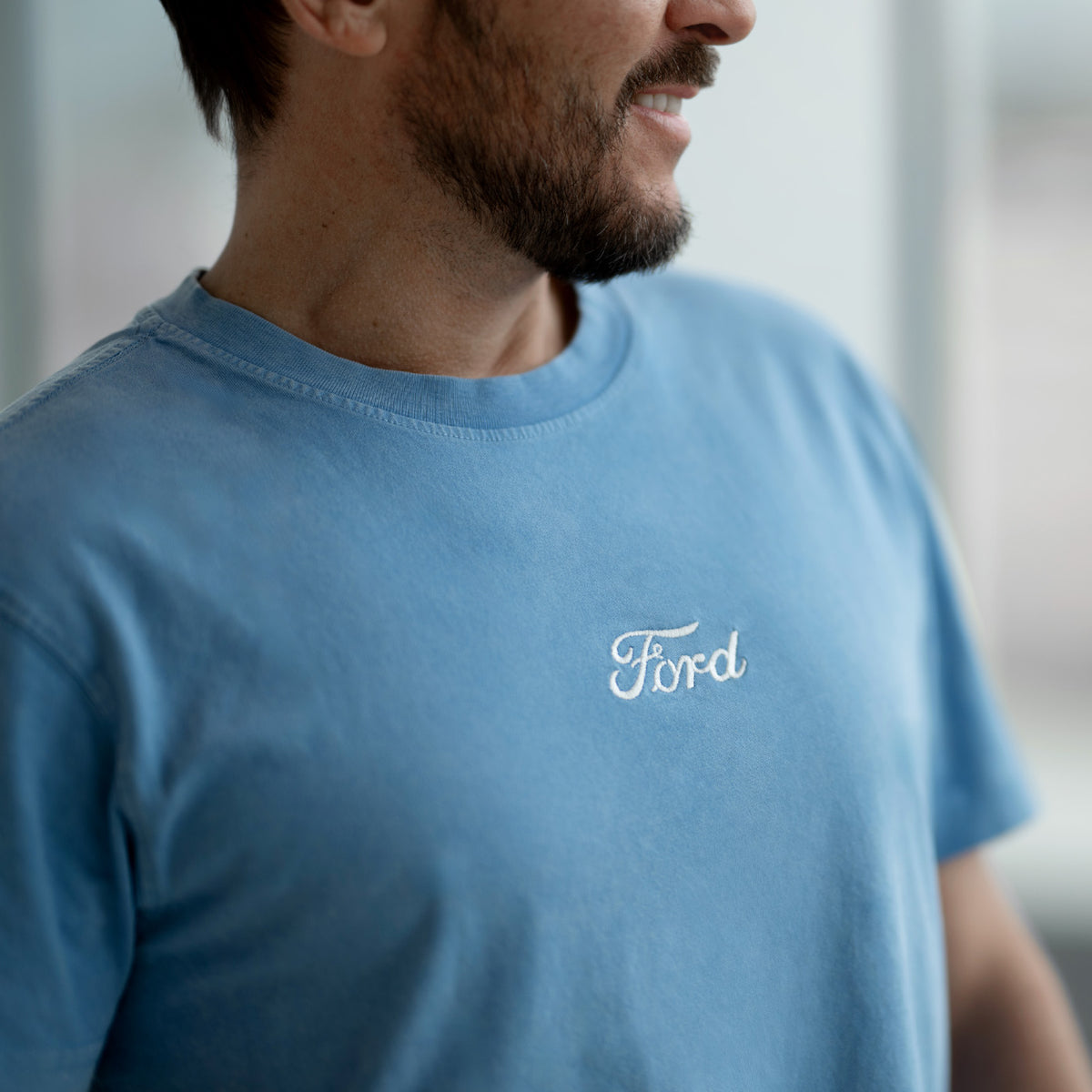 Man wearing a blue t-shirt with 'Ford' logo