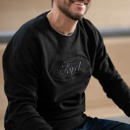 Person wearing a black sweatshirt with a Ford logo on a neutral background