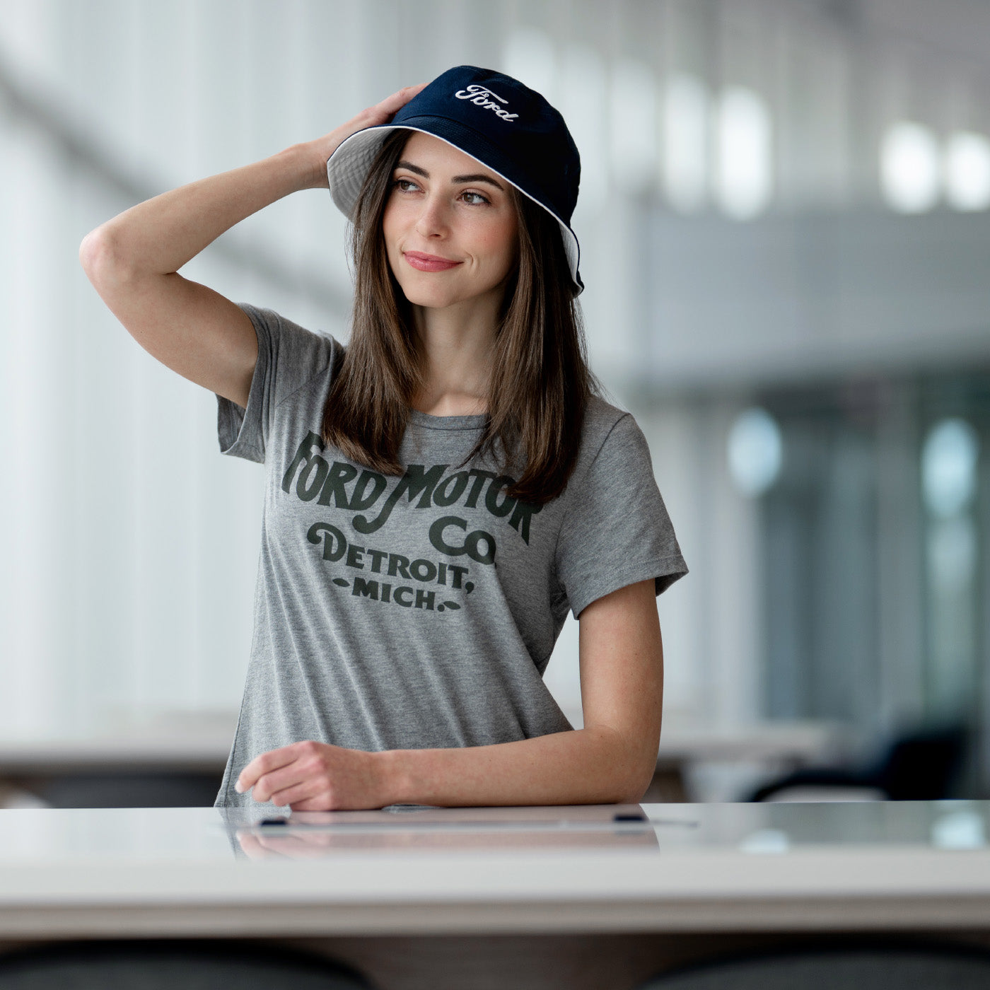 Woman wearing a Ford cap and t-shirt in an indoor setting
