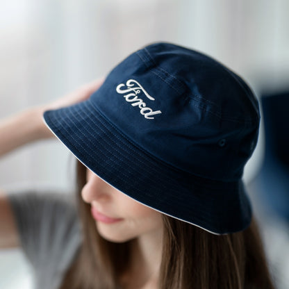 Person wearing a navy blue bucket hat with 'Ford' logo.