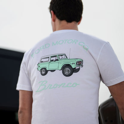 Person wearing a white t-shirt with a green Ford Bronco graphic on the back.