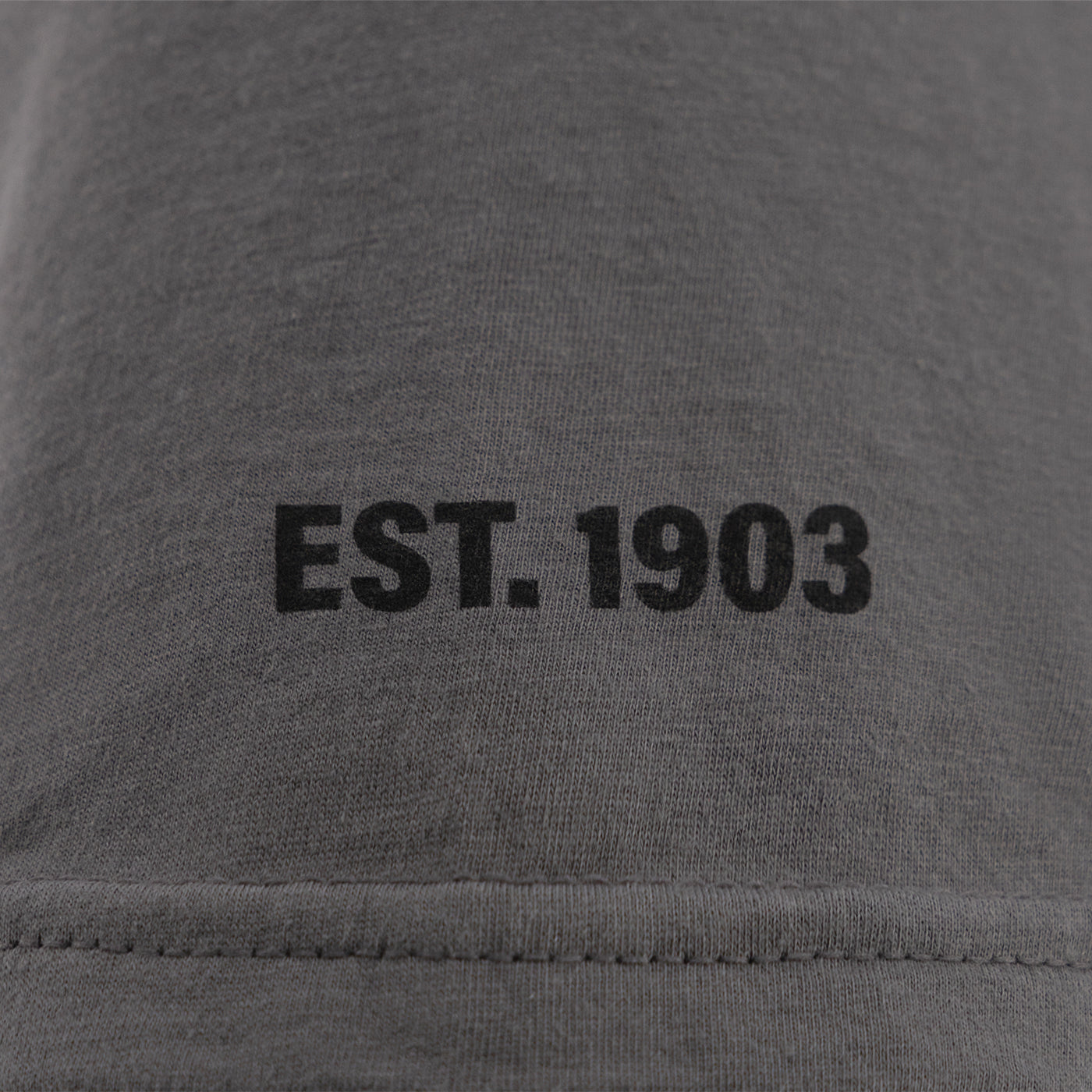 EST 1903 text on a gray background
