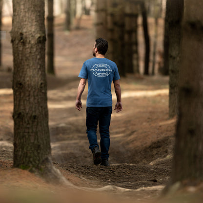 Man walking through a forest wearing a blue t-shirt with 'Ford Ranger' logo.