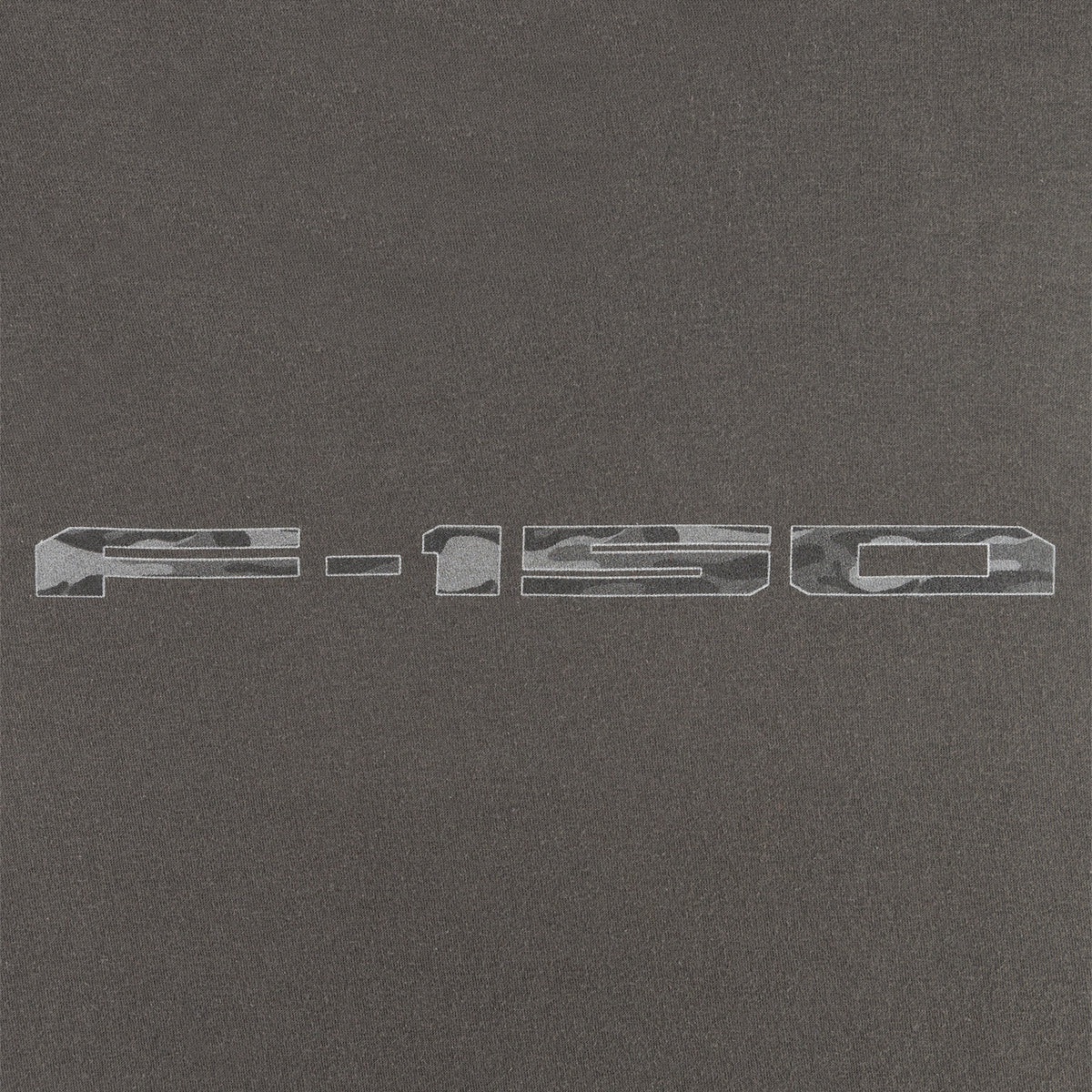 close up of a camo f-150 logo on a gray background