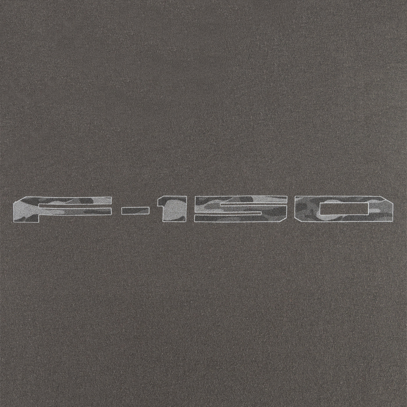 close up of a camo f-150 logo on a gray background