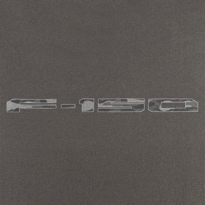 close up of a camo f-150 logo on a gray background