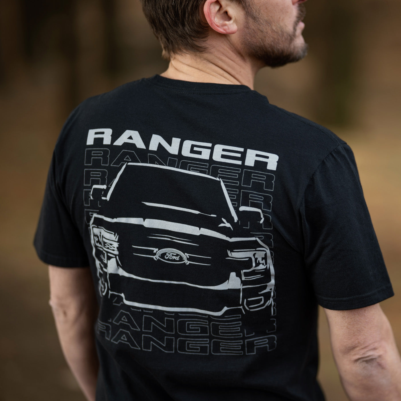 Person wearing a black t-shirt with 'Ranger' and truck graphic on the back.