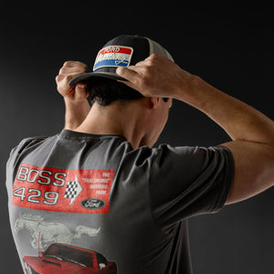 Person wearing a cap and t-shirt with Ford Boss 429 graphics on a dark background