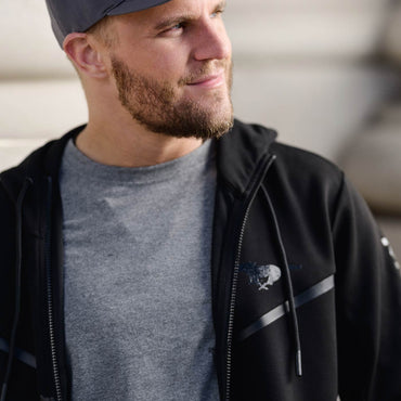 man smiling with gray t shirt and black mustang full zip hoodie