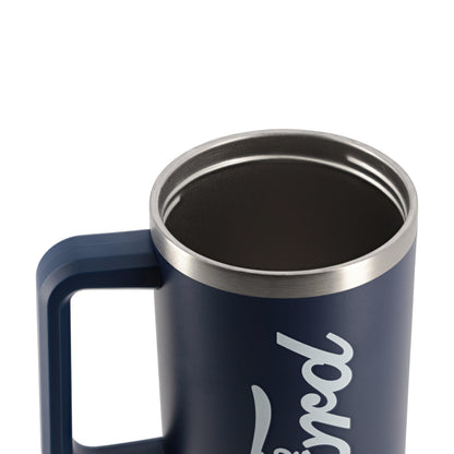 Close-up of a navy blue insulated mug with a stainless steel rim and a white script logo on the side, shown against a plain white background.