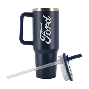 A navy blue insulated travel tumbler with a handle, featuring a white Ford logo printed on the side. The tumbler is shown with its clear lid and clear straw accessory on a plain white background.