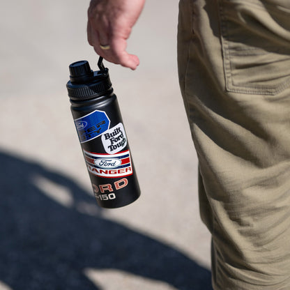 man holding a black Ford Trucks water bottle with patches on a cream background