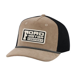 A trucker-style baseball cap with a tan corduroy front and brim, black mesh back panels, and a black-and-white embroidered patch reading 'TORD MOTOR COMPANY' on the front.
