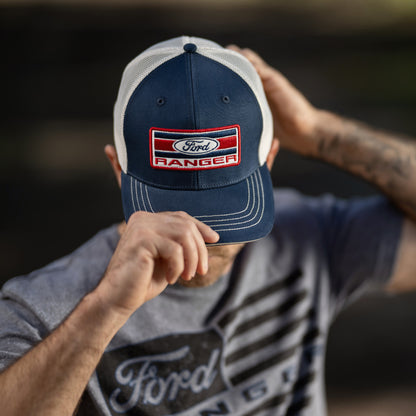 man in a gray ranger shirt wearing a navy blue hat with an americana ford ranger patch