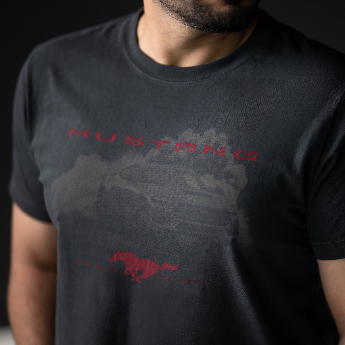 close up of red mustang text and a mustang graphic on a black t-shirt on a man with a beard