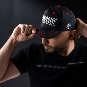 man wearing a Mustang GT hat with a checkered flag and pony logo with red stripe details.