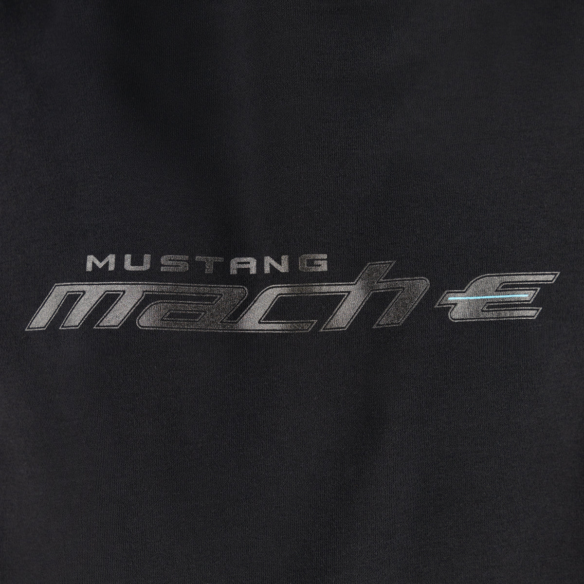 close up of Mustang mach-e logo text on a black background