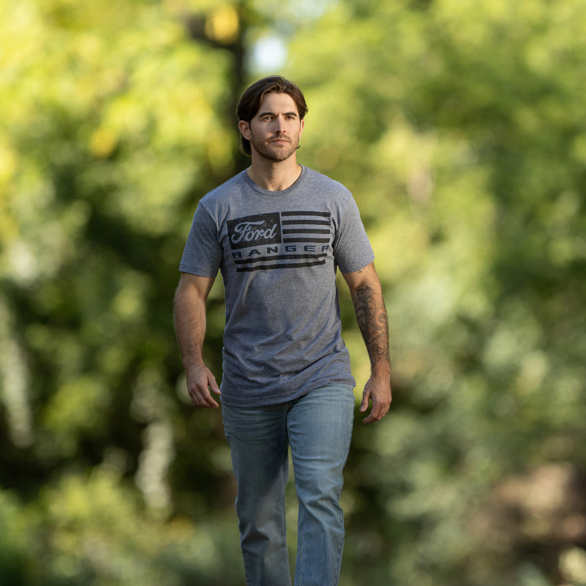 man wearing a Ford ranger american flag graphic gray t-shirt walking outside