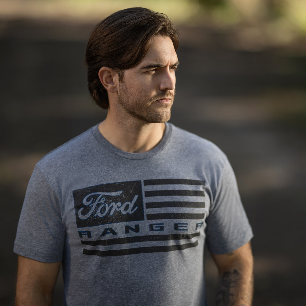 man wearing a Ford ranger american flag graphic gray t-shirt walking outside