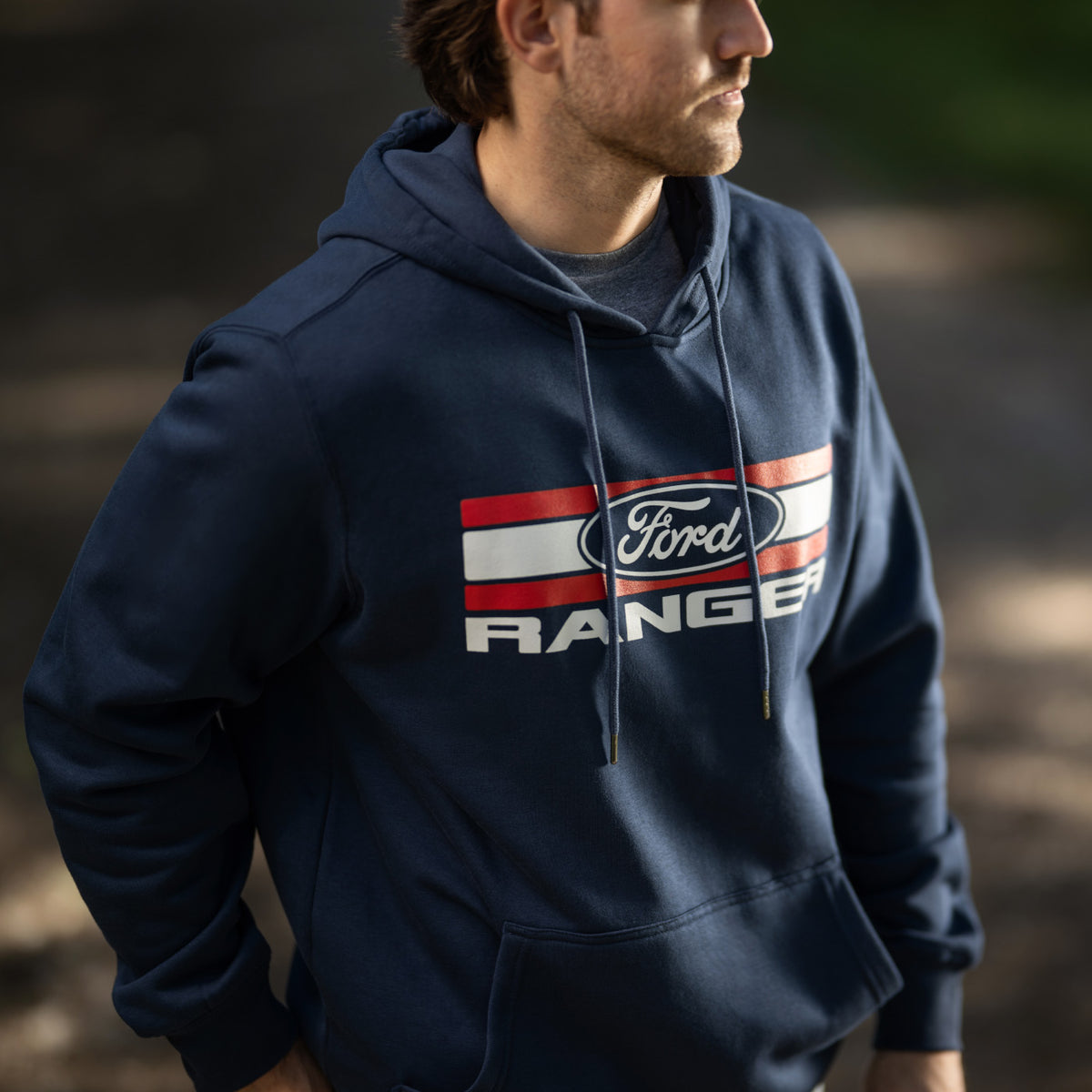man outside wearing an americana Ford Ranger sweatshirt in navy blue