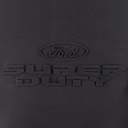 close up of embossed ford oval logo and super duty text on a black background