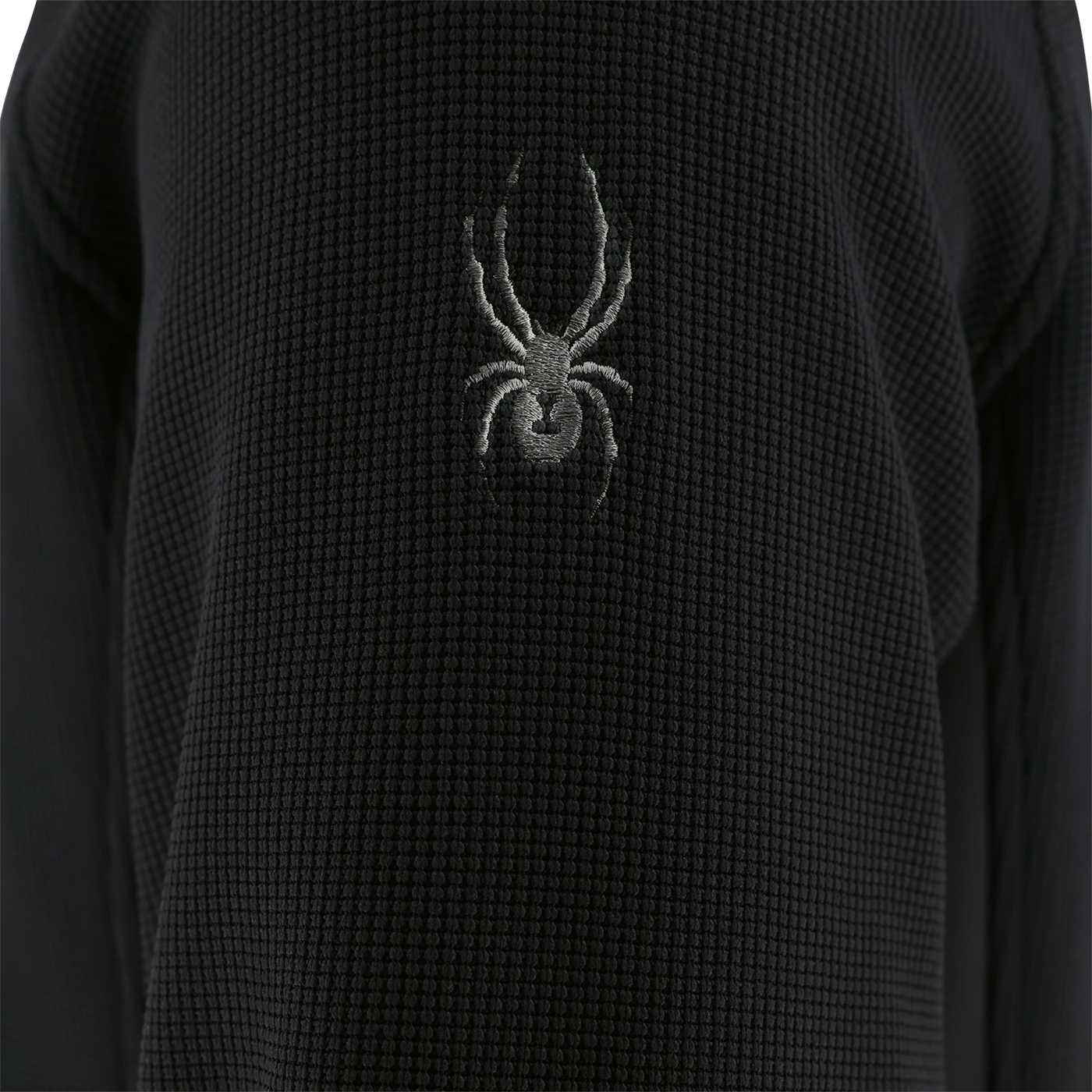 Black textured fabric with a spider logo on a dark background