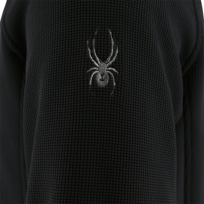 Black textured fabric with a spider logo on a dark background