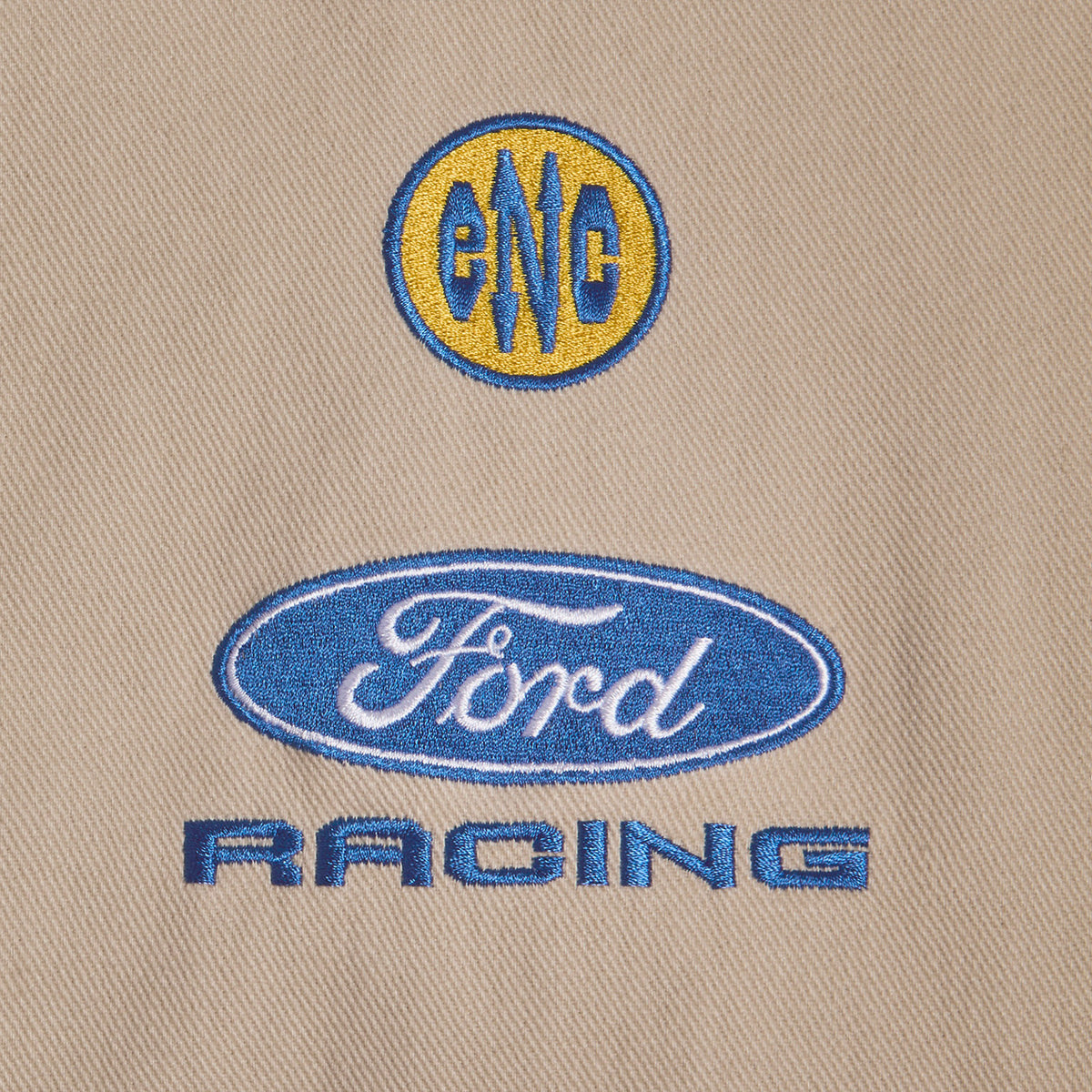 close up of ENC and Ford Racing patches on a tann background