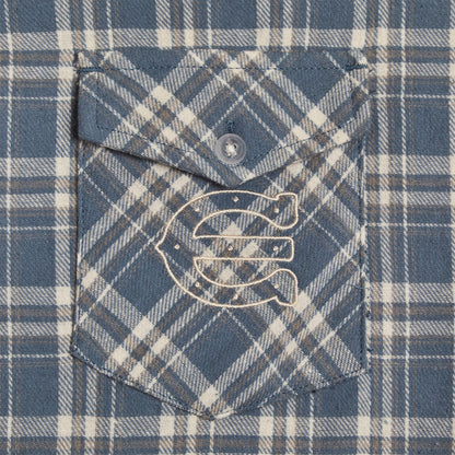 close up of an embroidered enchante  on a blue plaid button pocket