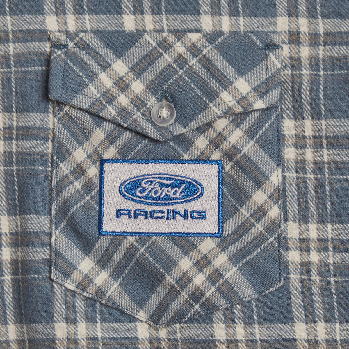 close up of a Ford Racing patch on a plaid blue buttoned pocket