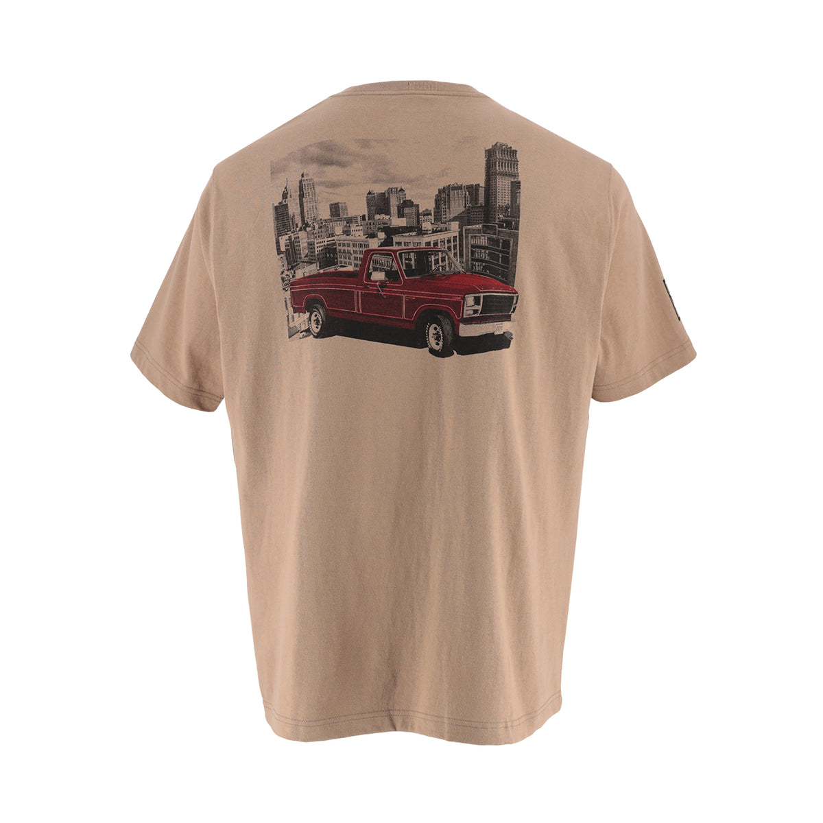 A beige short-sleeve t-shirt shown from the back, featuring a large graphic print of a red vintage pickup truck in front of a black and white city skyline.