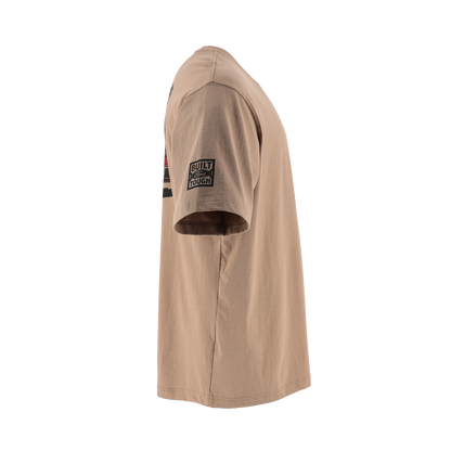 A side profile view of a tan crewneck t-shirt featuring a black and white graphic patch on the left sleeve that reads 'BUILT FORD TOUGH