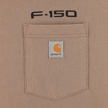 Close-up of a tan Carhartt F-150 pocket with a white Carhartt logo patch and black 'F-150' text above it.