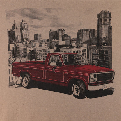 A vintage red pickup truck printed on a tan background with a city skyline illustration behind it.
