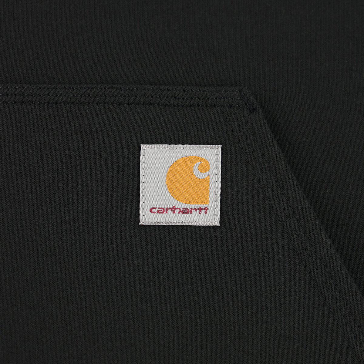 close up of a carhartt label on a black background