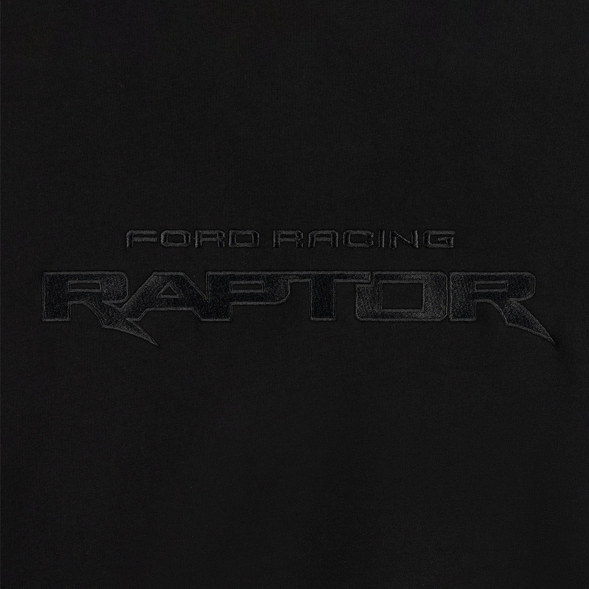 close up of embroidered Ford Racing Raptor text on a black background