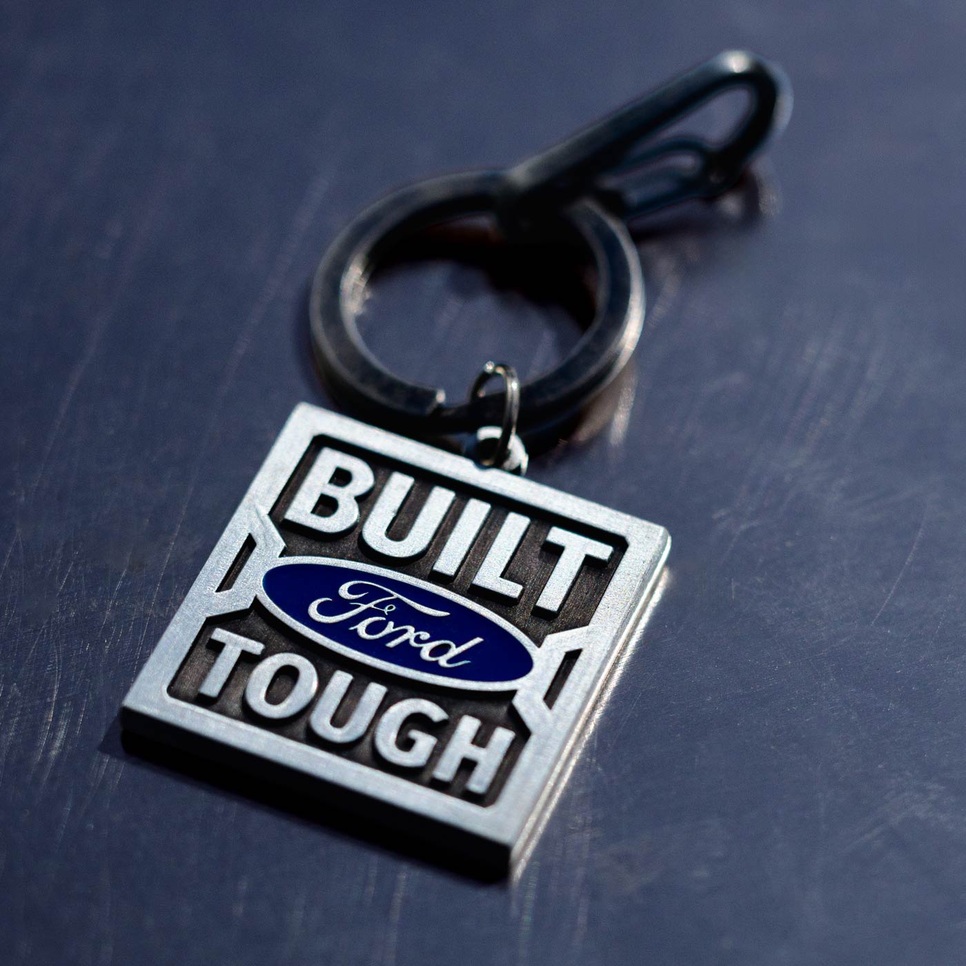 Keychain with 'Built Ford Tough' text on a dark surface