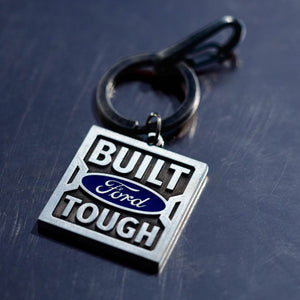 Keychain with 'Built Ford Tough' text on a dark surface
