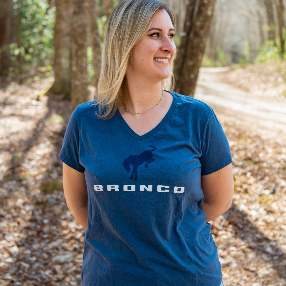 women wearing a dark blue t shirt with a bucking bronco and bronco logo