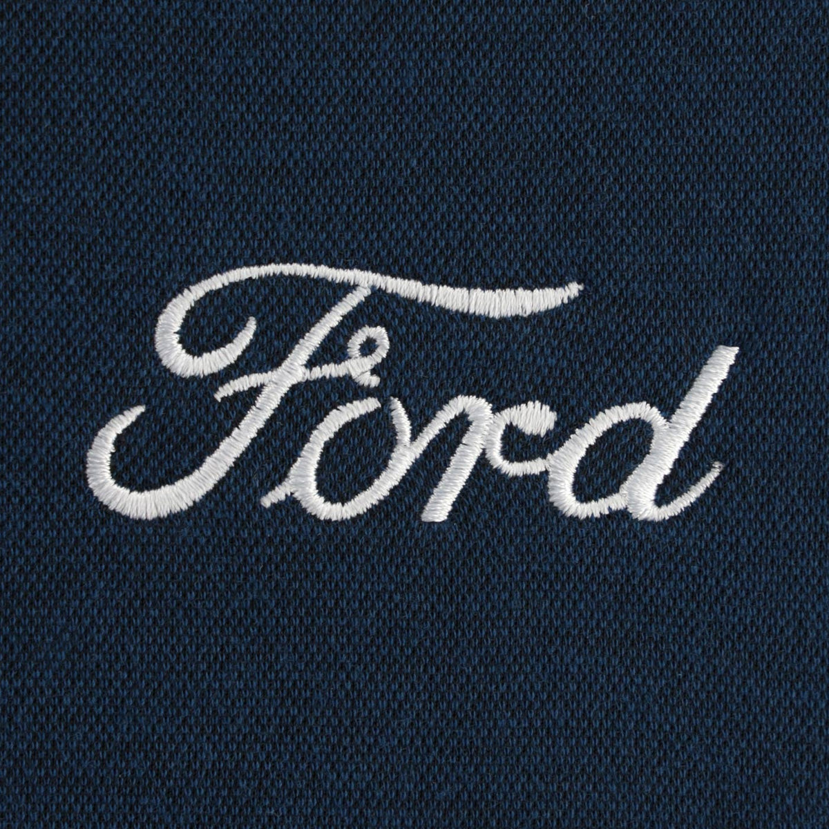 Embroidered Ford logo on a dark fabric background