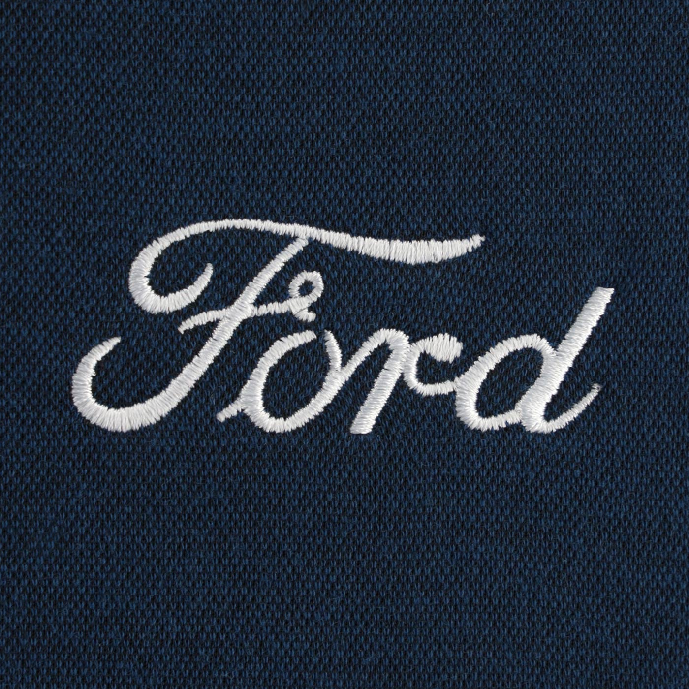 Embroidered Ford logo on a dark fabric background