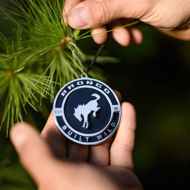 bronco built wild est 1966 enamel ornament on a pine tree