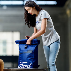 Woman interacting with a blue Ford bag in an urban setting