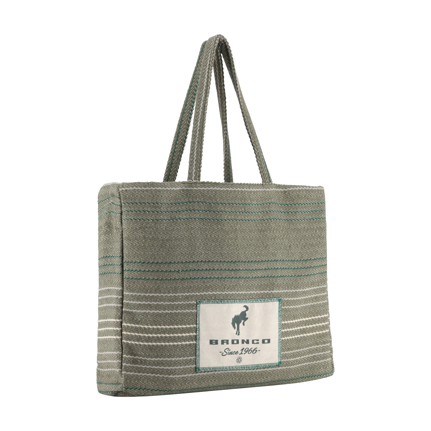 A woven tote bag in a muted sage green color with thin teal and white horizontal stripes, featuring a white rectangular patch on the front with the brand name 'BRONCO' and a horse logo.