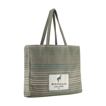 A woven tote bag in a muted sage green color with thin teal and white horizontal stripes, featuring a white rectangular patch on the front with the brand name 'BRONCO' and a horse logo.
