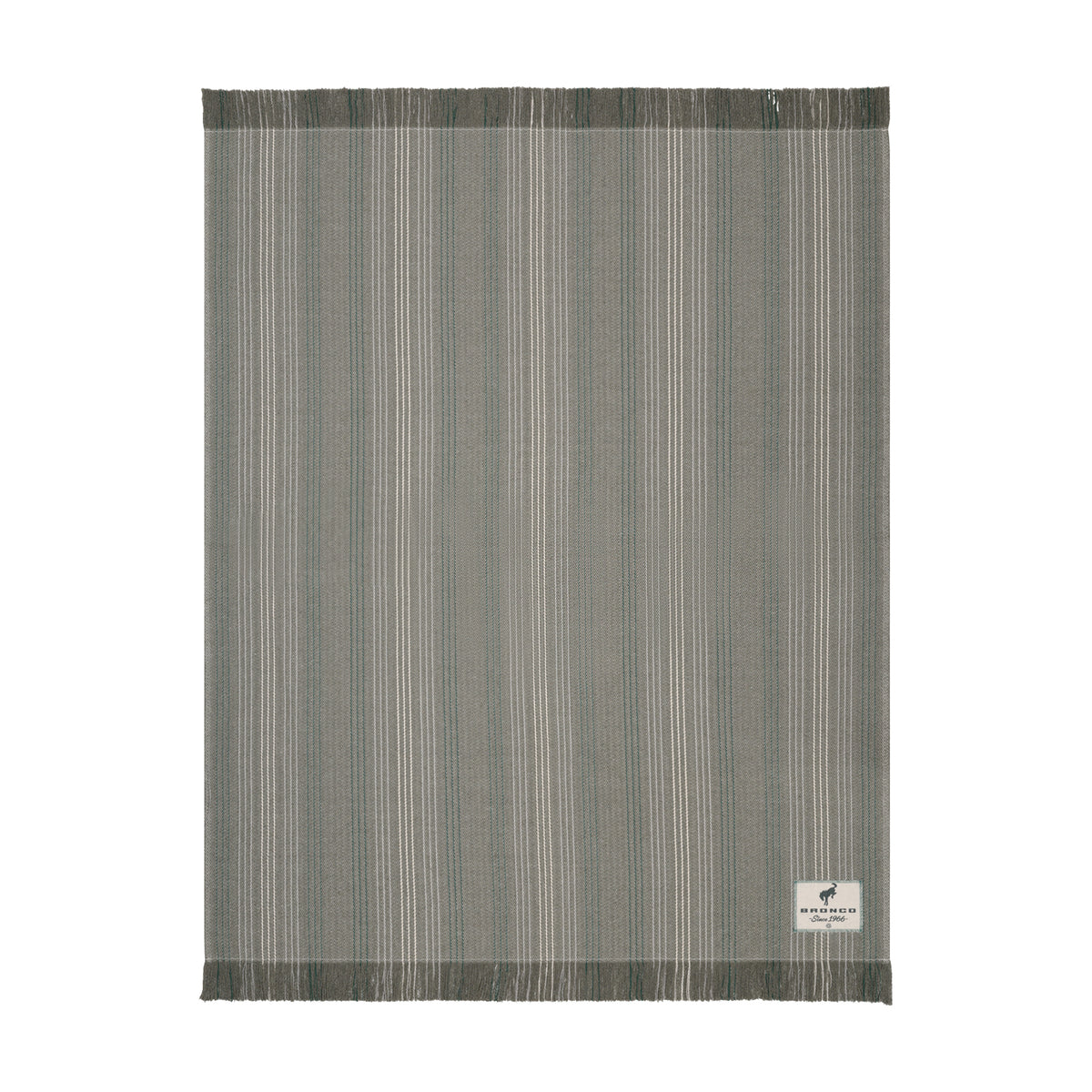 A rectangular woven rug with a vertical stripe pattern in shades of gray, beige, and white, featuring fringed edges and a small white brand label in the bottom right corner.