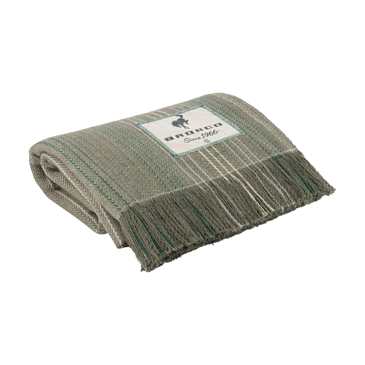 A folded woven throw blanket in a heathered gray and beige pattern with teal stripes and fringe, featuring a white brand label that reads 'andco Since 1966'.