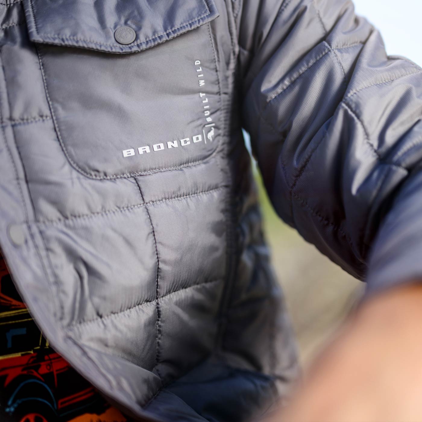 close up of pocket on gray quilted bronco built wild coat
